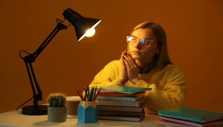 Study table with a student and reading lamp.