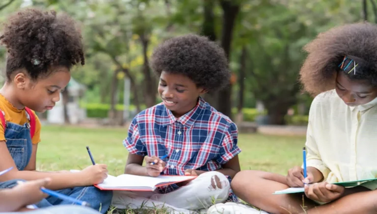 Outdoor education of children reading in an open space.