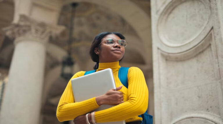 Scholarship: Girl holding laptop